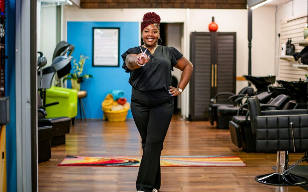 Woman in salon gives peace sign towards camera